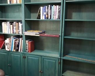 There are boxes of books...that will be in these shelves the day of the sale. These fun Green Bookcase/Cabinets are for sale!