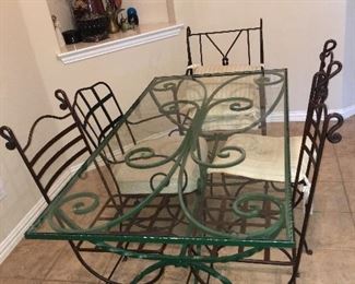 Vintage metal and glass top table with mix and match metal chairs