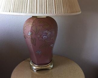 Pair of Lamps in a shade of mauve.  Round table with glass top