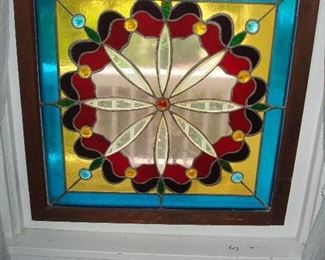 Dining Room: A framed stained glass window hangs from chains. It measures 27-1/2" wide x 27-3/4" tall.