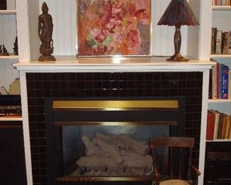 Family Room: A "bronzed" figure and a reproduction water lily "Tiffany-style" stained glass lamp flank an original abstract painting by artist Grace Stone, Maxine's mother. On the hearth are antique irons (closer photos coming soon) and a child's antique chair.