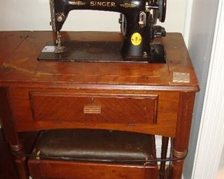 Family Room: An antique SINGER sewing machine folds into its case. The bench is part of the unit.