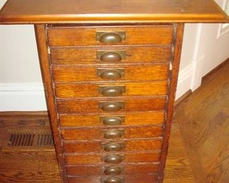 Family Room: A antique 11-drawer oak printer's cabinet has a false top (it lifts off).