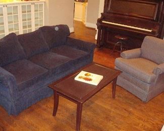 Family Room: The KRAVET 75" long sofa has three detached back cushions and three detached seat cushions. The narrow wooden coffee table has one drawer, and the club chair with navy blue design is by SOUTHWOOD (a closer photo of the upholstery is next).