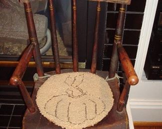 Family Room: A child's antique chair has a small bunny chair pad.