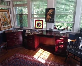 Sun Room/Office: The cherry finish desk with pull-out keyboard has two shallow drawers and a file drawer on each side. It measures 65" long x 20" deep x 30" tall. The matching two drawer lateral file measures 30" wide x 20" deep x 30" tall. The nearby art and stained glass are also for sale. A closer photo of the antique rug follows.