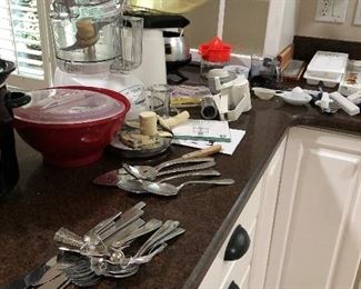 Two sets of silverware, food processor, corn popper
