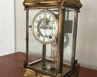 Antique New Haven Clock Company Thoreau Clock. Beautiful antique brass clock with front and back doors and winding key. Glass panes are beveled.