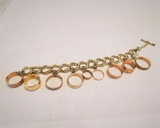 Vintage charm bracelet comprised of wedding rings. One ring is 18K, one is 14K and the others are 10K.