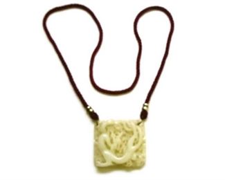 7. Carved Asian Jade on Red Cord.