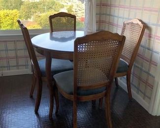 36 in Round Dining Table with 4 Cane back chairs.