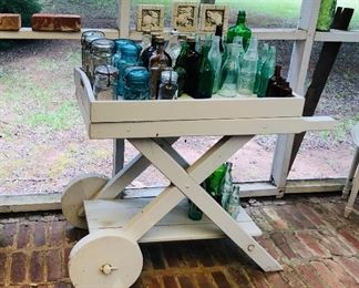 Porch tea cart with bottles and jars