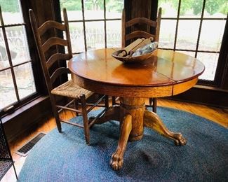 Victorian round claw foot dining table, antique dough bowl with rolling pins, ladder back chairs with corn shuck bottoms
