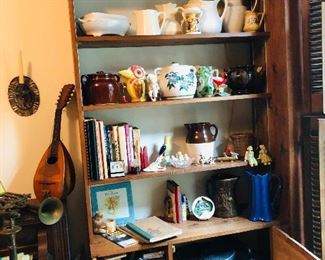 stereo with turntable and cassette player/ vintage mandolin and trumpet, books , collection of pitchers and bean pots.