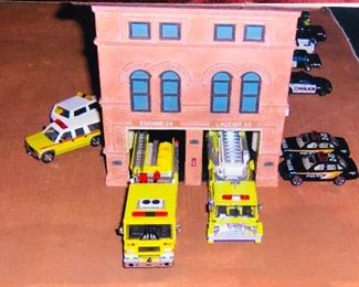 Cars with one of the model buildings 