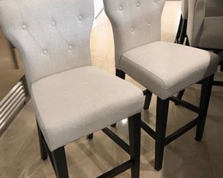 Two fabulous bar stools. The fabric seems very durable and my guess is you can take a damp rag and clean them. Perfect condition, as is everything else in this home.