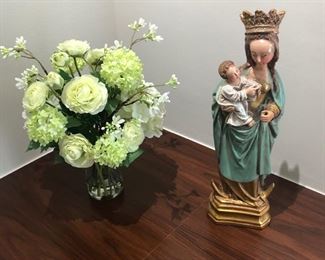 This is an incredibly lovely statue of the BVM holding the baby Jesus. It's very old.