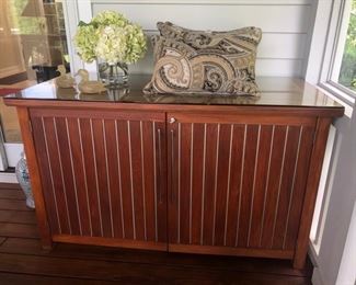This is a teak storage credenza. It locks.