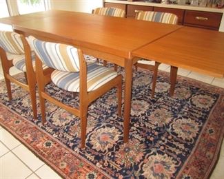 TEAK TABLE WITH PULL OUT LEAVES ON EACH SIDE. LIFT TABLE TOP AND SLIDE IN