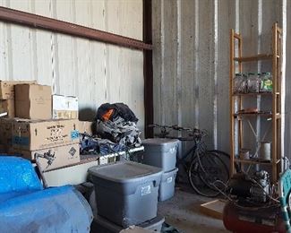 Lawn Chairs, Books in Boxes, Wooden Shelving, Flight Suits in Bins, Blue Tarps