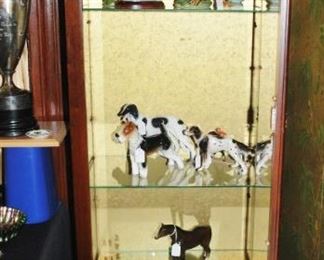 Display cabinet with porcelain dogs and birds