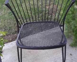 Two fan back wrought iron chairs and table