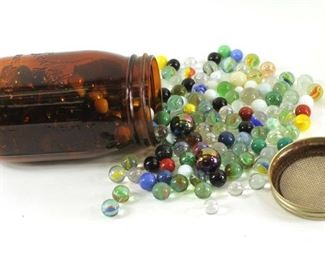 vintage marbles and a brown glass canning jar