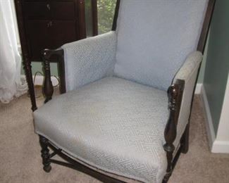 upholstered armchair and small cabinet with drawer