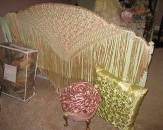beautiful ribbon shawl draped over the end of the bed
