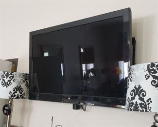 32-inch television with wall mount. You must take it down and are responsible for moving