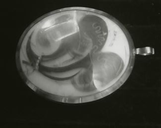 Ra re large 14K pendant with human hair. This side also contains a tiny pearl necklace. The other side is a full color portrait .