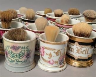 Antique collection of porcelain shaving mugs and brushes