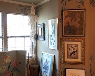 A full bedroom of pictures and paintings