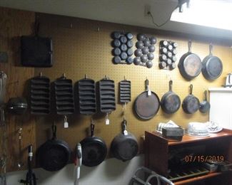 Some of these cast iron have been taken by family.  Five (5) skillets remain, 2 corn cob forms, and 1 muffin (pictured top row, first one on left.