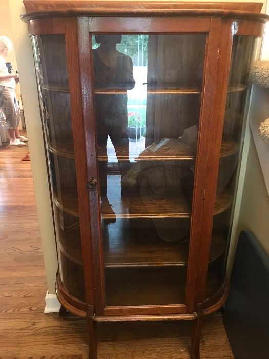 Early 1900's China Cabinet -  Looking at the front of this piece, the left side was replaced with plastic.  Glass is on the other two sections.    The wood is in good condition.