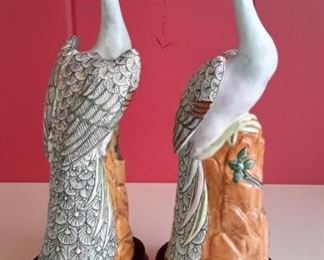 Two beautiful porcelain peacocks on wood bases.