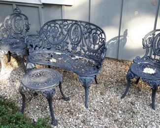 Heavy cast iron bench, two chairs and small table.