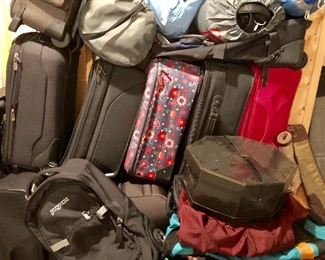 Large collection of suitcases and sleeping bags