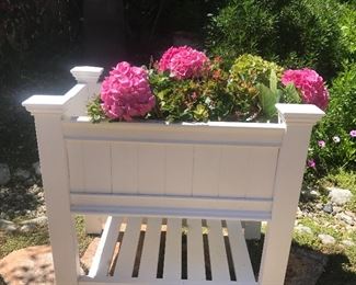 There are many outdoor patio items   here a large planter in white