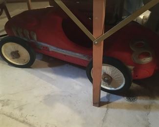 . . . this was hidden under a table, but I think it is an old pedal car!