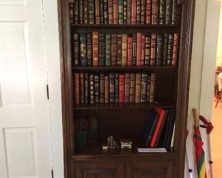 Bookcase with Franklin Library leather bound books. "Collected stories of worlds greatest writers".