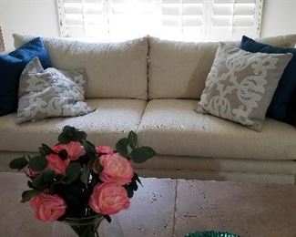 Off white sofa and lots of pillows.