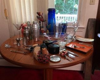 Various vintage and mid-century bar items, pitchers, coaster collection, and trays.