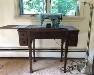 Singer sewing machine and table with drawers.