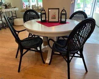  White Crate and Barrel kitchen table w/1 leaf —4 black wicker chairs - sold separately 