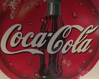Several Coca-Cola Button Signs