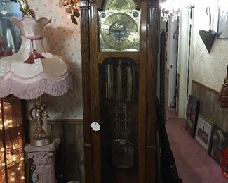 Magnificent Oak Howard Miller Clock with Large Pendulium
    (Height 83” x Width 20.5”, 
      Depth 14.5”)