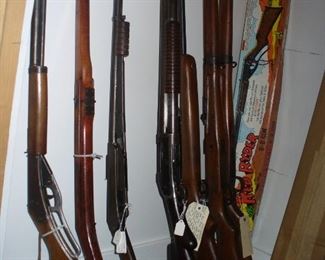 DAISY BB GUNS INCLUDING THE FAMOUS CHICAGO WOODEN - 2ND FROM LEFT, MORE DAISY GUNS IN THE TWO BOXES, 2 JAPANESE RIFLES AND WINCHESTERS. LOOK AT JAPANESE BAYONET AND DAISY SCOPE NEXT PICTURES