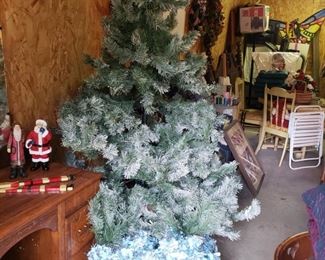 many Christmas trees and decorations in both garages