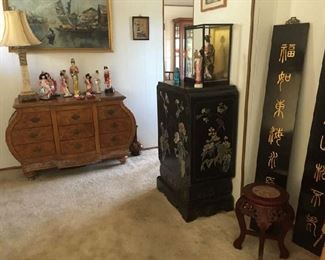 Frontroom. Nice bow-front chest,  Oriental chest and two wall black wooden plaques.